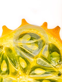 Kiwano or Horned Melon Cucumis metuliferus sliced in a half on white background isolated