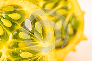 Kiwano or Horned Melon Cucumis metuliferus sliced in a half on white background isolated