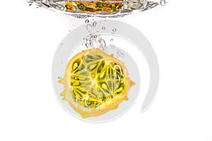 Kiwano or Horned Melon Cucumis metuliferus sliced in a half on white background isolated