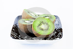 Kiwi on a black and white plate