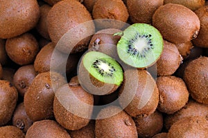 Kiwi. Fresh organic kiwis in knitted basket. Slice of colorful green kiwi fruit with seeds. Fruits background texture. Kiwi wallpa