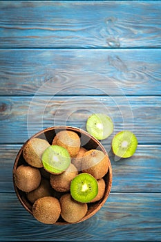 Kiwi fruit in bowl on blue wooden rustic table