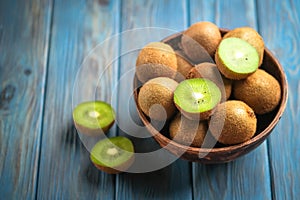 Kiwi fruit in bowl on blue wooden rustic table