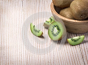Kiwi fruit in a bowl on wooden
