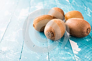 Kiwi fruit in a bowl on wooden background.