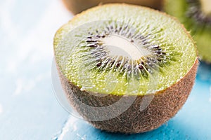 Kiwi fruit in a bowl on wooden background.