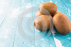 Kiwi fruit in a bowl on wooden background.