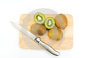 Kiwi fruit on chopping board isolated