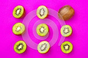 Kiwi fruit pattern on pink colored background, minimal flat lay style, copy space.