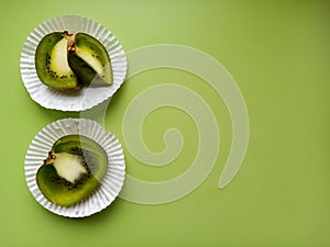 Kiwi fruit spread out on White paper plates. Healthy food concept.