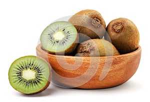 Kiwi fruit whole and half in a wooden plate on a white background. Isolated