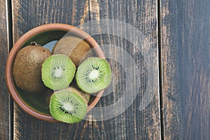 Kiwi fruit on wooden background with copy space