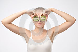 Kiwi. Healthy fruit funny woman holding kiwi fruit for her eyes.