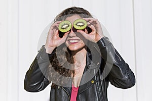 Kiwi. Healthy fruit funny woman holding kiwi fruit for her eyes.