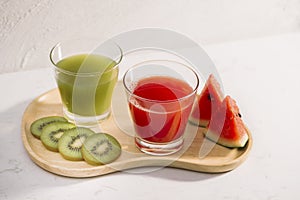 Kiwi juice and watermelon with fruit Slices on wooden tray