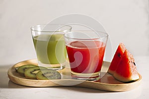 Kiwi juice and watermelon with fruit Slices on wooden tray