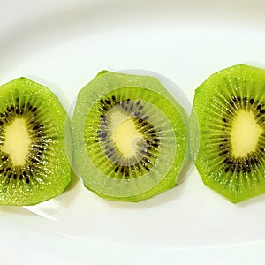 Kiwi on a plate. Close-up macro photo of healthy green tropical fruit