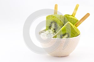 kiwi popsicle isolated on white background made with fresh fruits inside bowl with ice