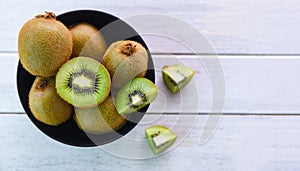 Kiwi slice in bowl / Fresh kiwi fruit on the table wooden background