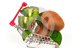 Kiwi with slices and green leaves in metal trolley