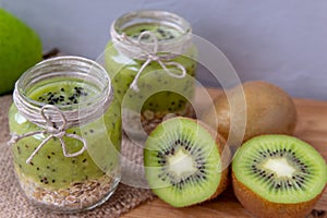 Kiwi smoothie with cereal on a wooden table