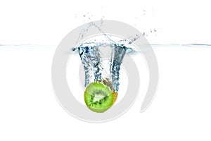 Kiwi in water splash, isolated on white background.