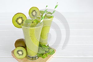 Kiwi Yogurt Healthy Fruit Smoothie Drink in the morning on a white wood background.