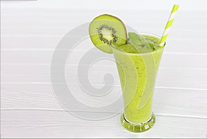 Kiwi Yogurt Healthy Fruit Smoothie Drink in the morning on a white wood background.