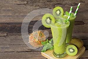 Kiwi yogurt smoothies juice,beverage healthy the taste yummy In glass drink episode morning on wood background.