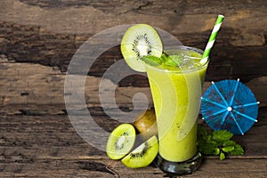 Kiwi yogurt smoothies juice,beverage healthy the taste yummy In glass drink episode morning on wood background.