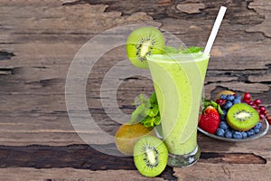 Kiwi yogurt smoothies juice and kiwi green fruit for breakfast in the morning on wood background.