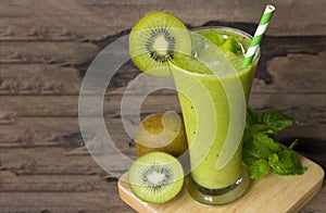 Kiwi yogurt smoothies juice and kiwi green fruit for breakfast in the morning on wood background.