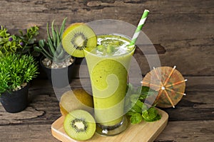 Kiwi yogurt smoothies juice and kiwi green fruit for breakfast in the morning on wood background.