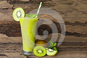 Kiwi yogurt smoothies juice and kiwi green fruit for breakfast in the morning on wood background.