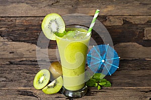 Kiwi yogurt smoothies juice and kiwi green fruit for breakfast in the morning on wood background.