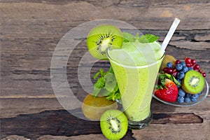 Kiwi yogurt smoothies juice and kiwi green fruit for breakfast in the morning on wood background.