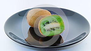 Kiwis on a black plate