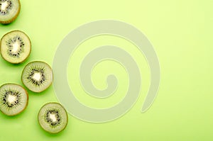 Kiwis on a green pastel background, copy space