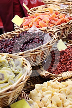 Kiwis, papayas, gojis in wicker baskets on the market stand