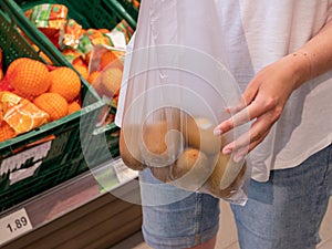 Kiwis in plastic bag in the supermarket