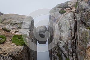 Kjerag stone, hanging on the cliff between two high rocks.