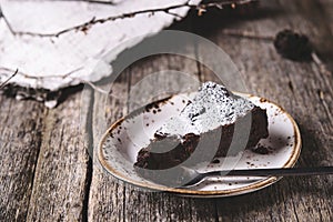 Kladdkaka. Traditional Swedish moist chocolate cake on old rustic wooden table