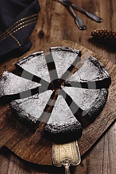 Kladdkaka. Traditional Swedish moist chocolate cake on wooden table