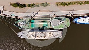 Klaipeda, Lithuania - april 26 2020: Aerial view, two ships moored at the quays at the Dane river in Klaipeda city.