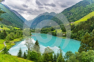 Klamsee - mountain water reservoir above Kaprun town with bright turquoise blue water, Austria