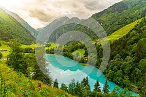 Klamsee - mountain water reservoir above Kaprun town with bright turquoise blue water, Austria