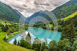 Klamsee - mountain water reservoir above Kaprun town with bright turquoise blue water, Austria