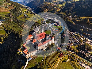 Klausen, Italy - Aerial view of the SÃ¤ben Abbey Monastero di Sabiona with Chiusa Klausen comune in South Tyrol Dolomites photo