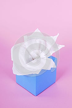 Kleenex style tissue box, pink background, copy space, vertical