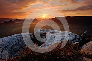 Kleiner Winterberg, beautiful morning view over sandstone cliff into deep misty valley in Saxony Switzerland, foggy background, th